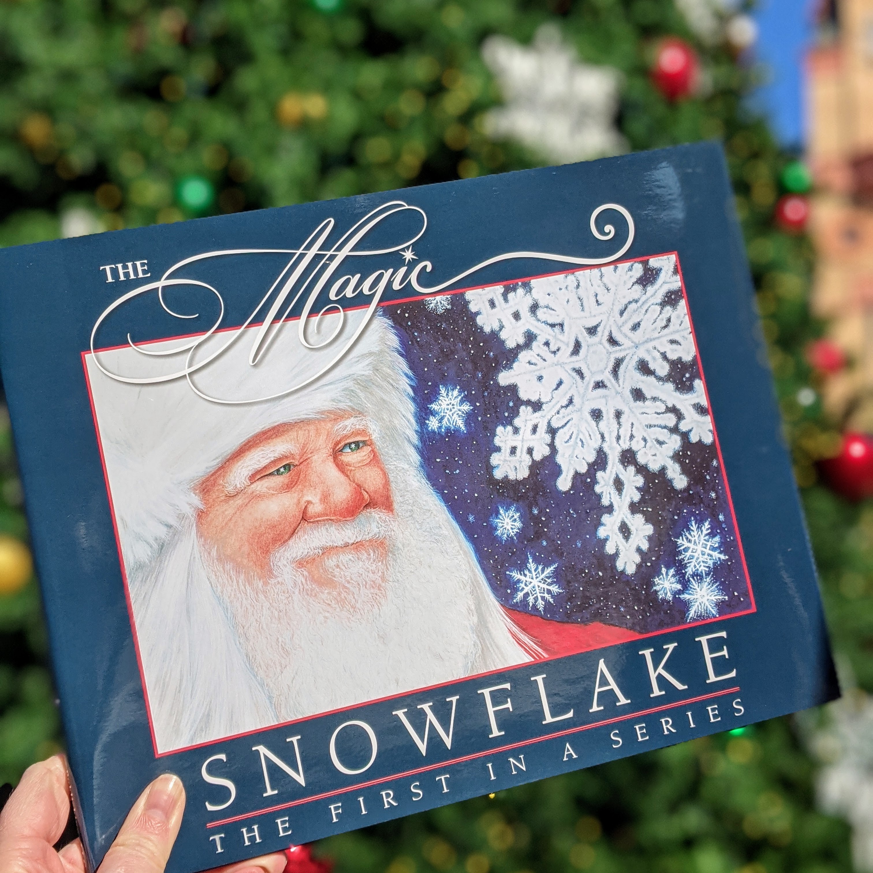The Magic Snowflake book in front of a Christmas Tree