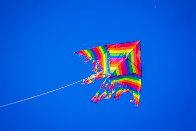 a colorful kite against a blue sky