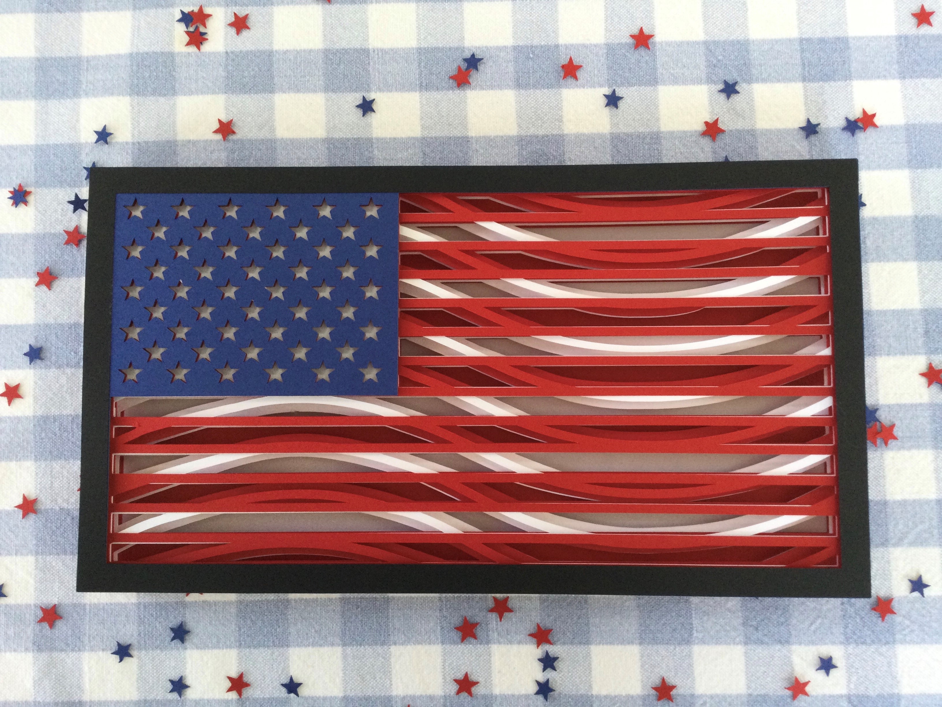 an American flag made out of cut paper.