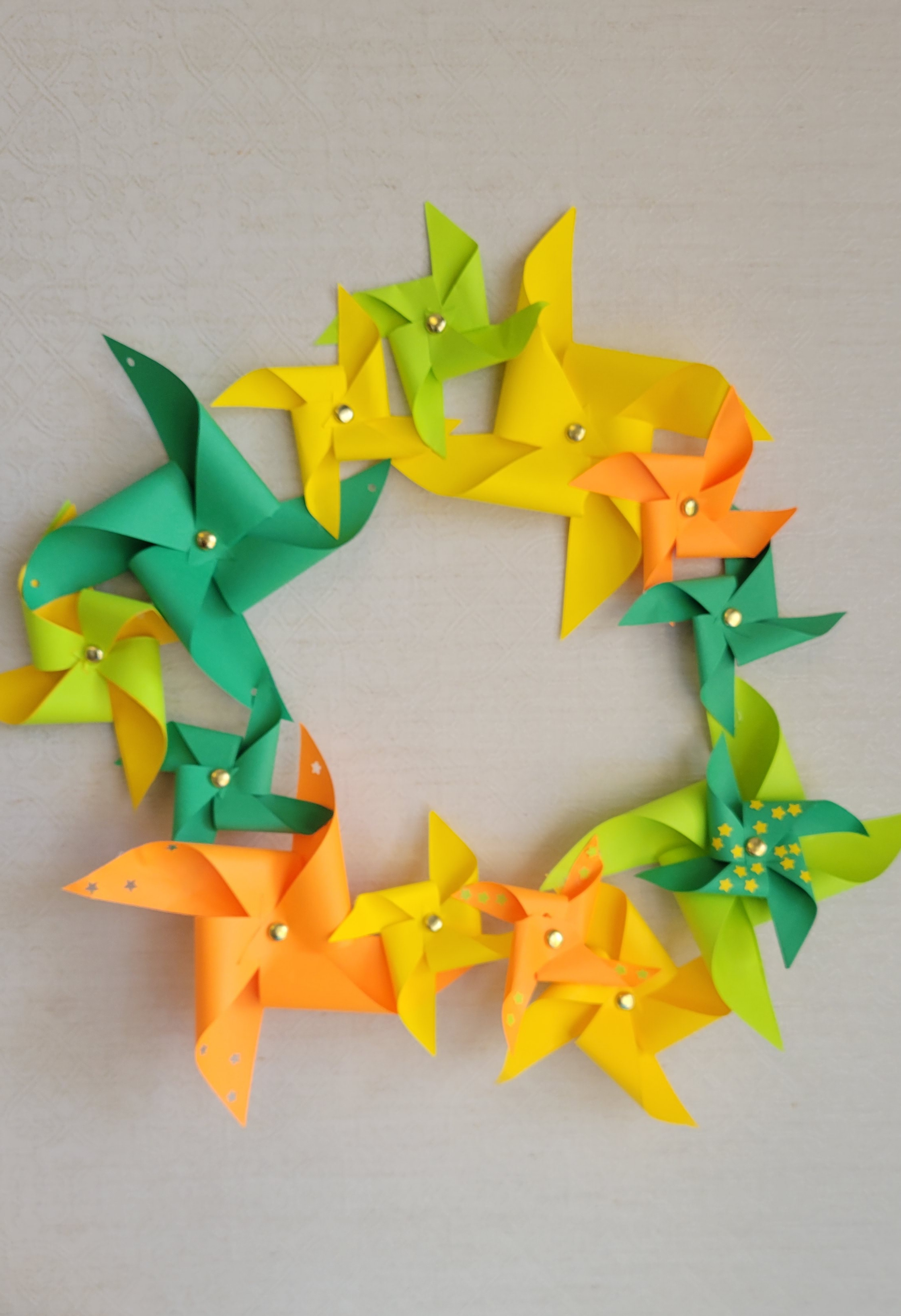 wreath make of pinwheels: light & dark green, yellow and orange