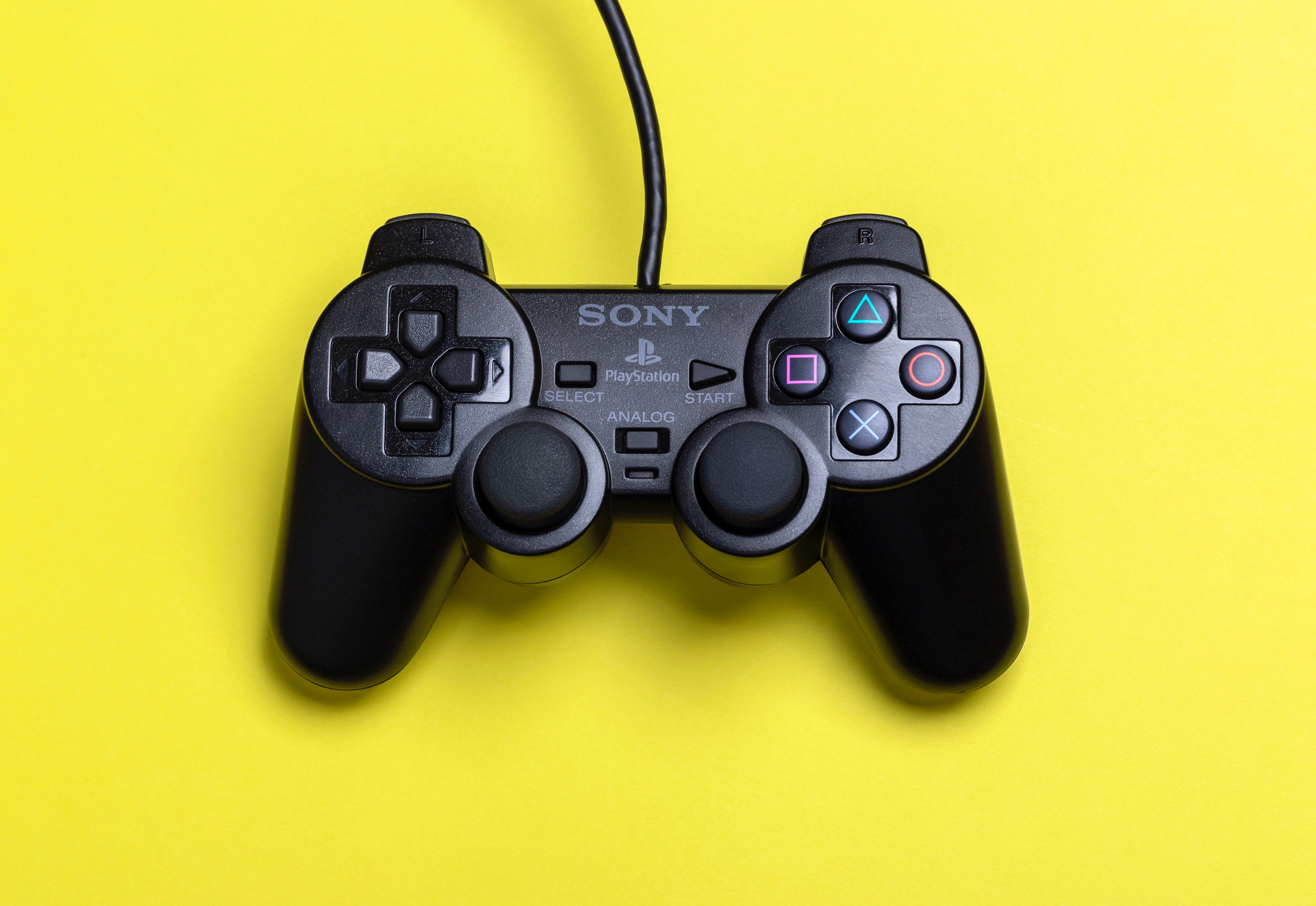 Playstation controller on yellow background