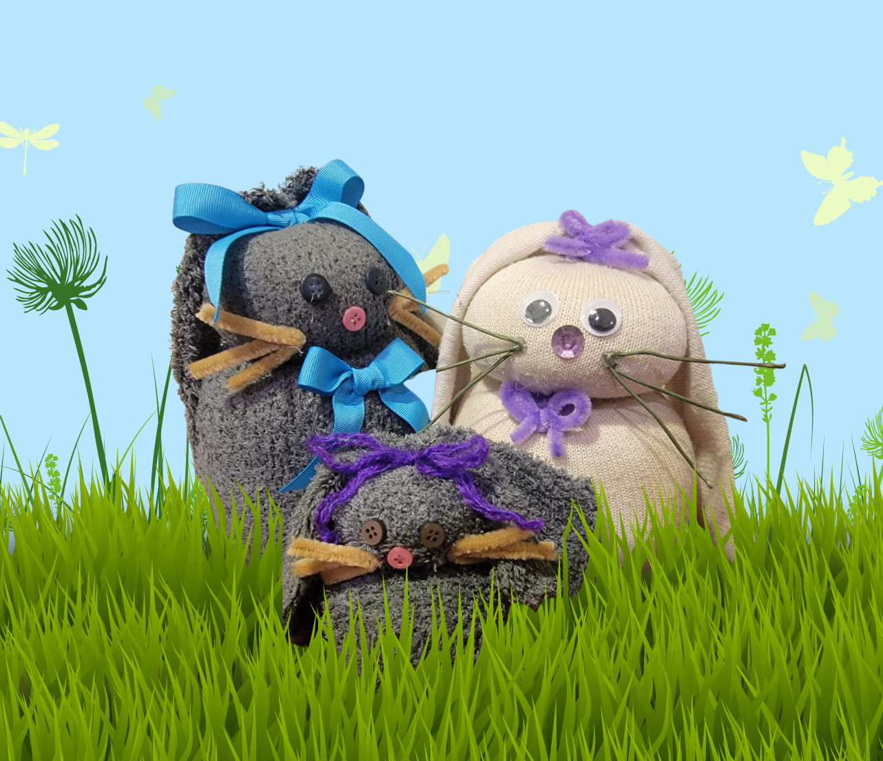three sock bunnies with a meadow background