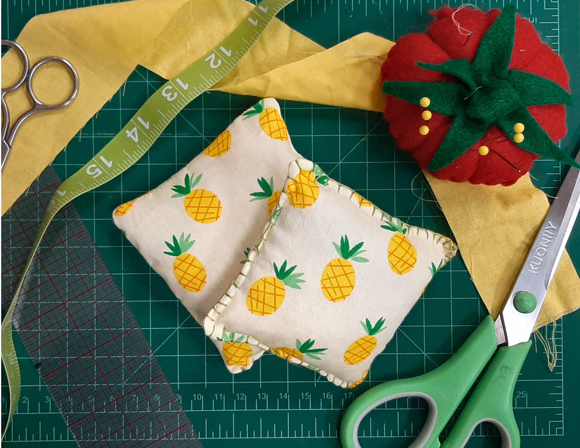 a pair of homemade handwarmers, made with pineapple print fabric. 