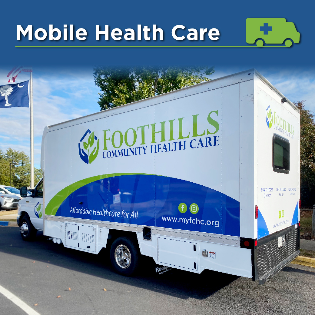 Photo of a white ambulance-style bus with blue and green Foothills Community Health Care logo