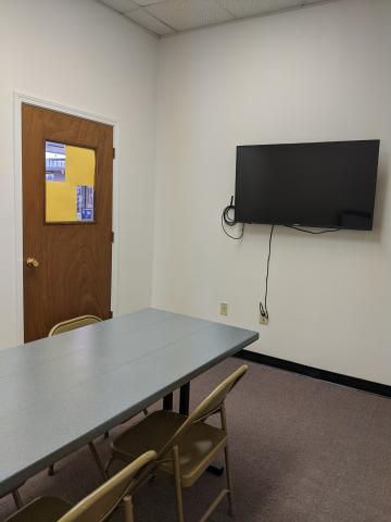 Piedmont Library Meeting Room image showing table, chairs, and mounted television