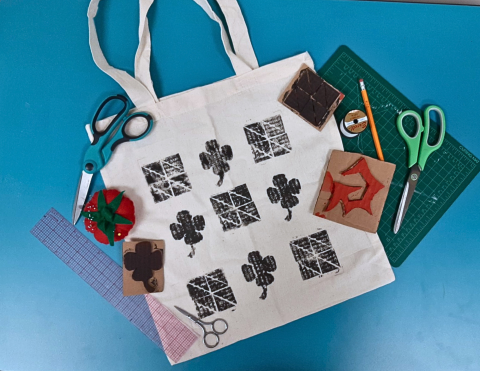 a tote bag with hand stamped designs of four leaf clovers 