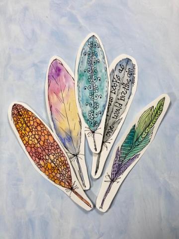 Brightly colored watercolor feather-shaped bookmarks