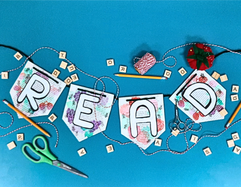 a banner made of book pages that says "READ"