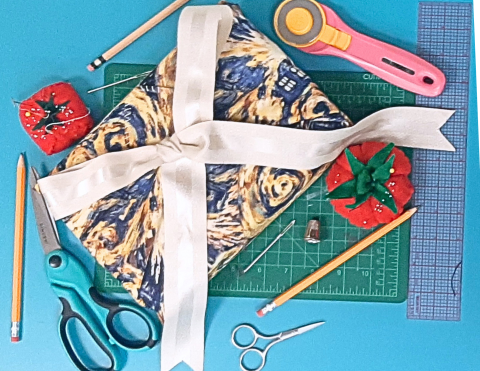 a fabric reusable gift wrapping with a white bow 